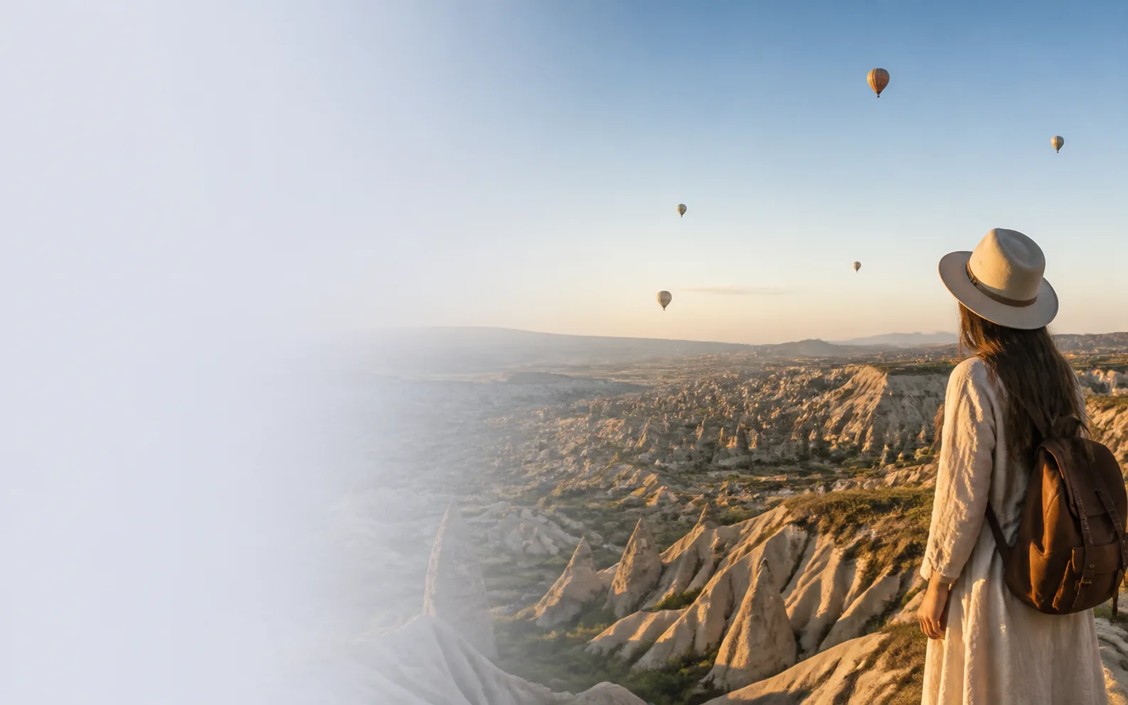 Traveler overlooking Cappadocia, Türkiye at sunrise